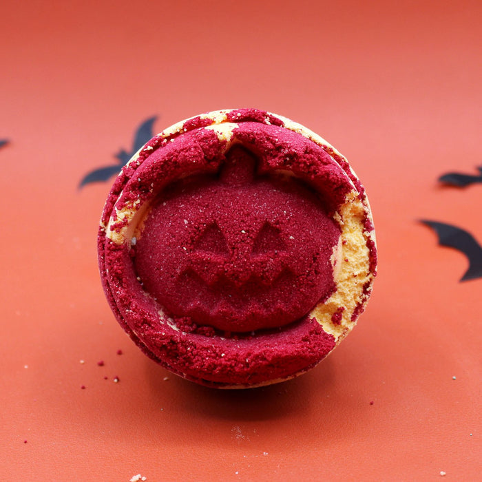 Halloween-themed cookie with red center and yellow rim on a red background