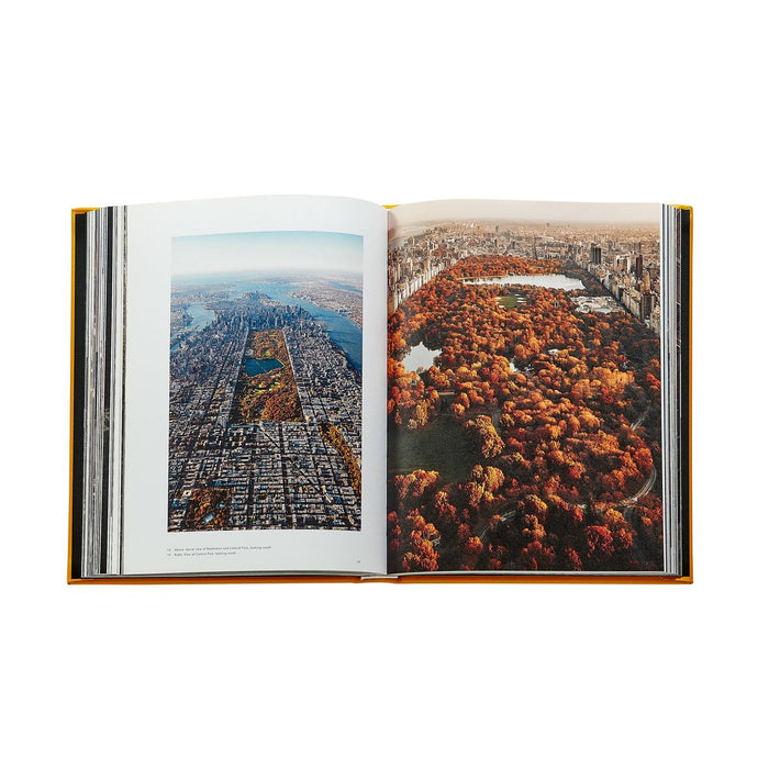 Open book showing aerial views of a cityscape and autumn foliage.