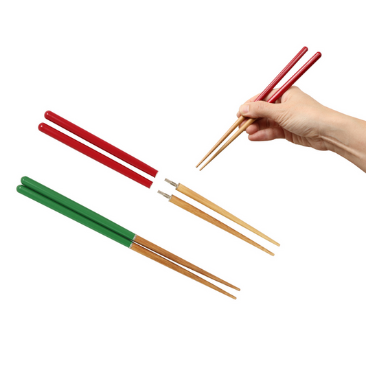 Set of colorful chopsticks with a hand holding red chopsticks on a white background