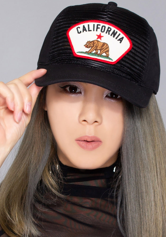 American Needle Cali Durham Brim Hat in black with embroidered California flag logo and mesh netting on tonal cotton twill festival baseball cap — model front view