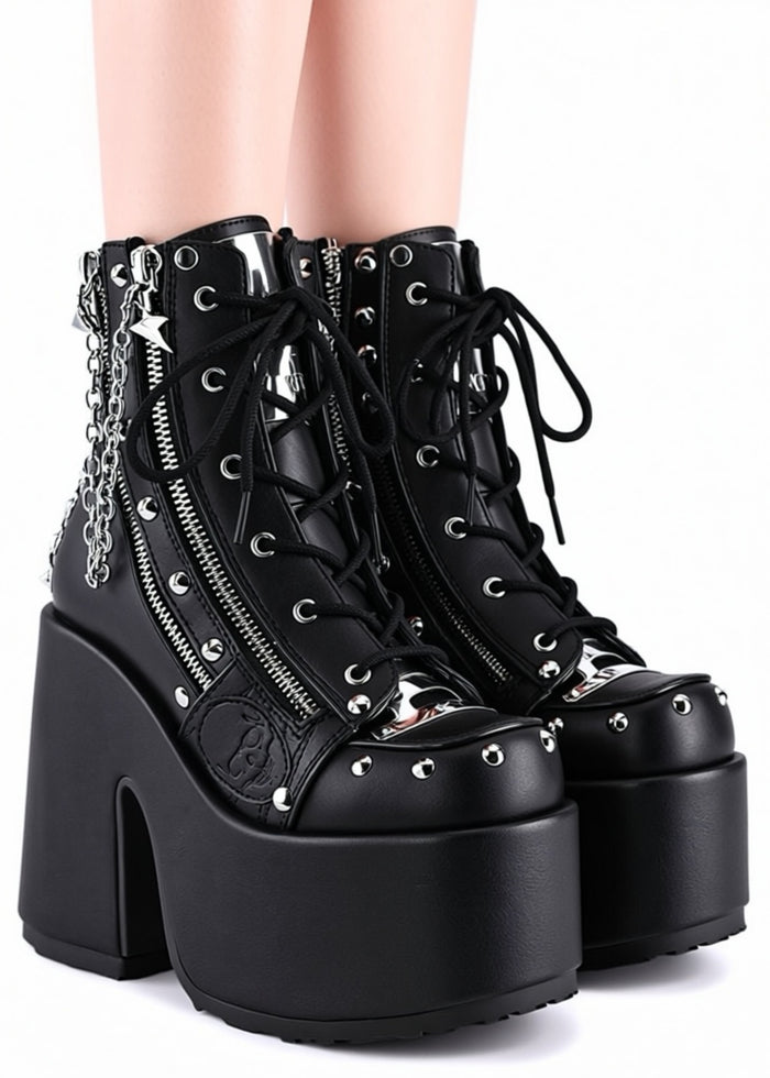 Demonia CAMEL 208 Punk Goth Black Rave Platform Boots in black vegan leather with dual metal zipper and silver chain hardware worn by model — side view