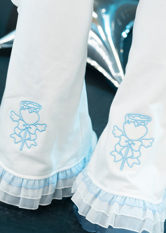 ACDC Rag Capsule Bunny Heart Hack White/Pastel Blue Leg Warmer in white with pastel blue ruffle trim hem on rave festival leg warmer — ruffle hem detail