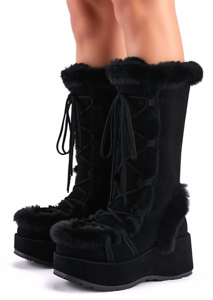 Demonia CUBBY 311 Black Rave Platform Boots in black vegan suede with faux fur trim and 2.75 inch platform worn by model — side view