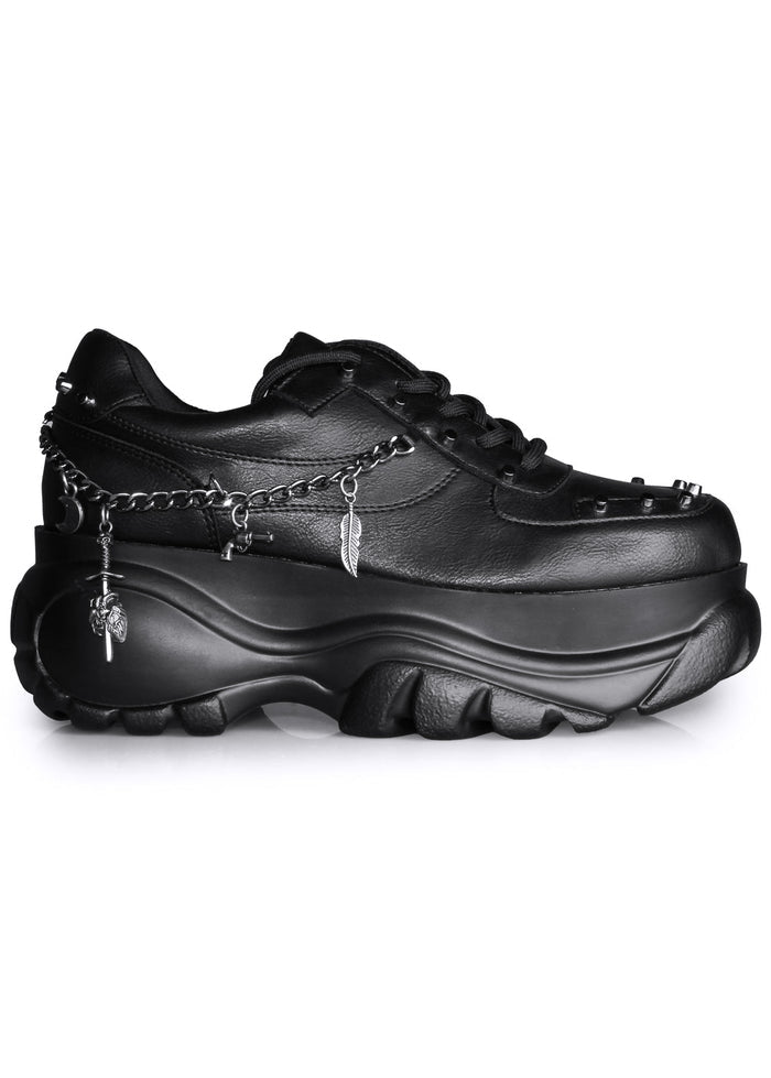 Side studio view of Anthony Wang DYNAMITE Bass Stomp black platform sneakers featuring silver hanging chainlink and stud details on a chunky flat rave outsole