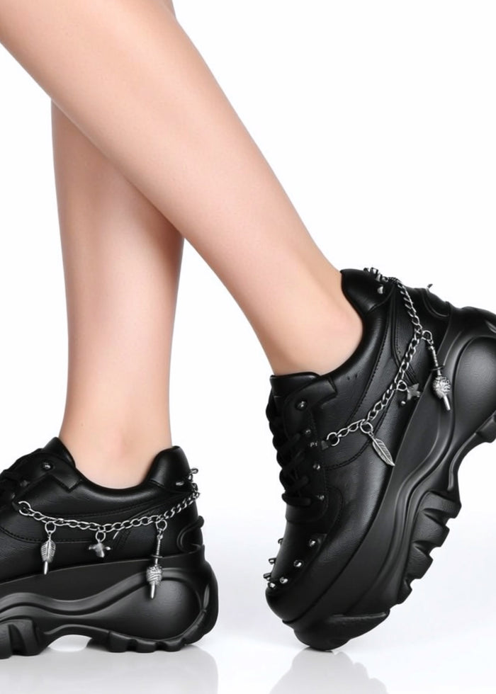 On-foot styling view from behind of Anthony Wang DYNAMITE Bass Stomp black platform sneakers showing the chunky flat outsole and high-top ankle fit