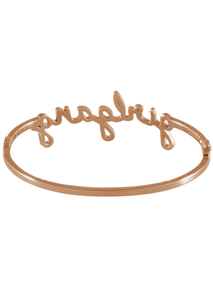 Wanderlust + Co Girlgang Bangle in rose gold with cursive girlgang script on rose gold plated stainless steel hinged bangle bracelet — back view