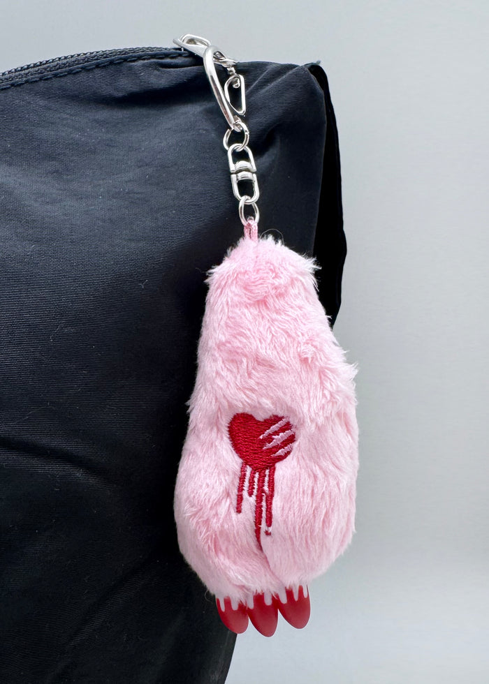 Gloomy Bear Bloody Claw Pink Plush Mascot Keychain in pink with Gloomy Bear plush and plastic bloody claw detail on metal clasp festival keychain — model view