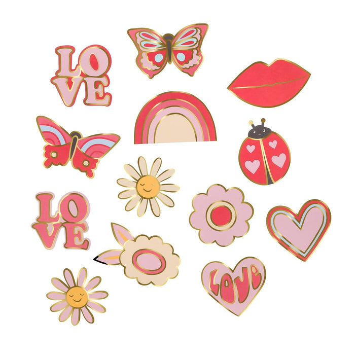 Collection of colorful decorative pins including butterflies, flowers, a rainbow, and lips on a white background.