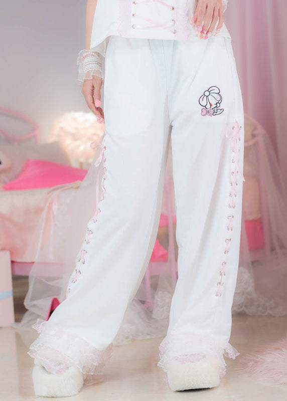 ACDC Rag Hanyo Usagi Chax Bunny White Pants in white and pink with ribbon lace-up side detail on rave festival pants — worn front view