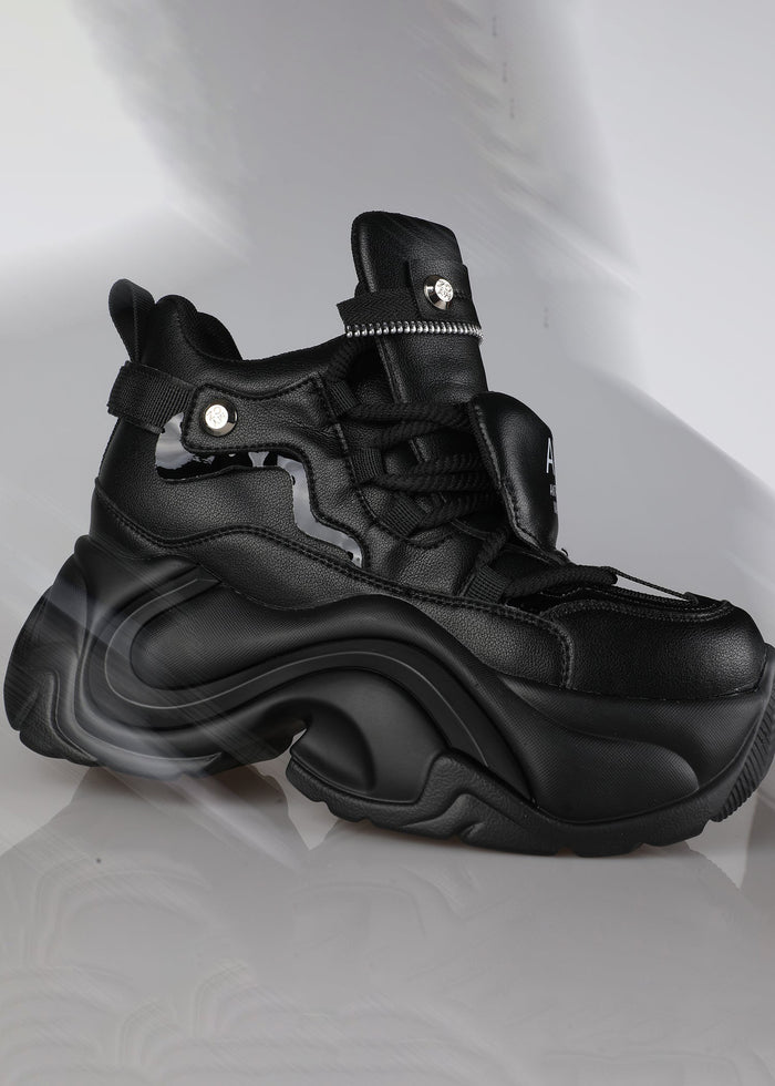 On-foot action shot of Anthony Wang JUPITER 04 Hack Mode Black platform sneakers under dark festival rave lighting showing the clean black cyber-core silhouette