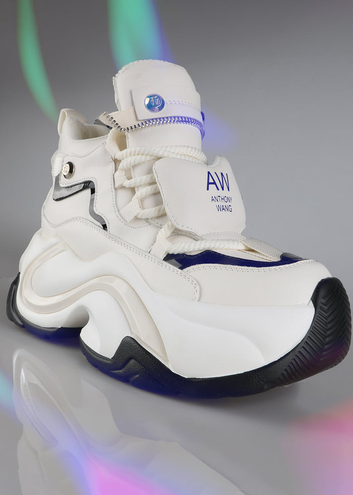 On-foot action shot of Anthony Wang JUPITER 04 Plasma White platform sneakers under festival rave lighting showing the clean white futuristic silhouette