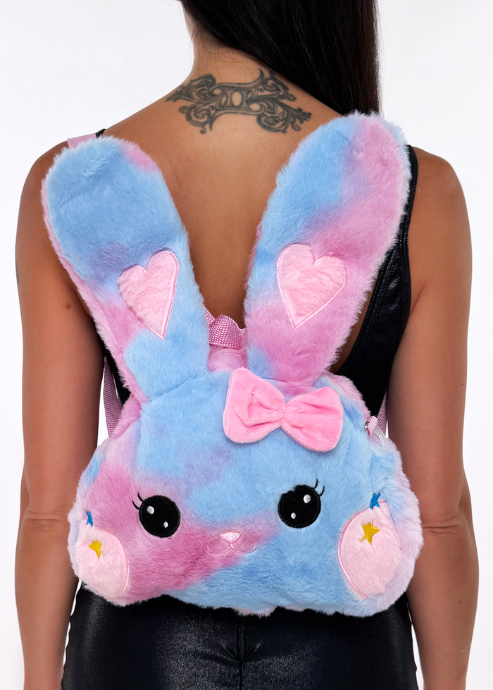 Sleepyville Critters Kawaii Pink Bunny Plush Backpack in pink with embroidered bunny face, floppy ears, and pink bow on soft girl rave backpack — model front view