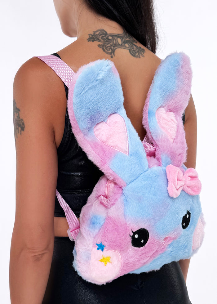 Sleepyville Critters Kawaii Pink Bunny Plush Backpack in pink with embroidered bunny face, floppy ears, and pink bow on soft girl rave backpack — model side view