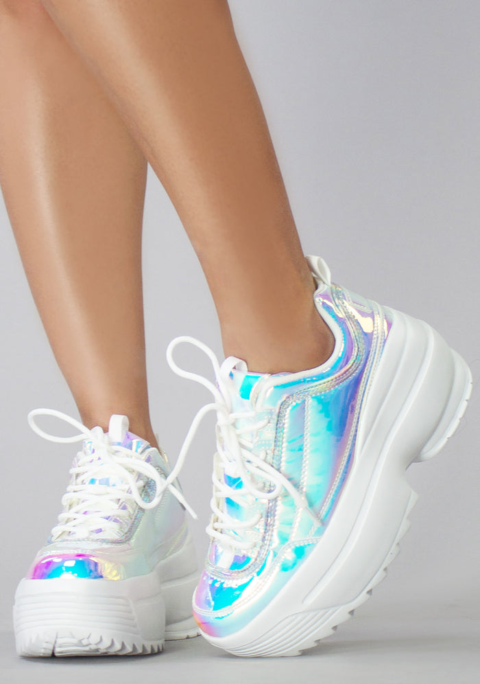 Front angled view of the holographic Cosmic Trance rave platform sneakers on-model, highlighting the classic lace-up design and crisp white laces.