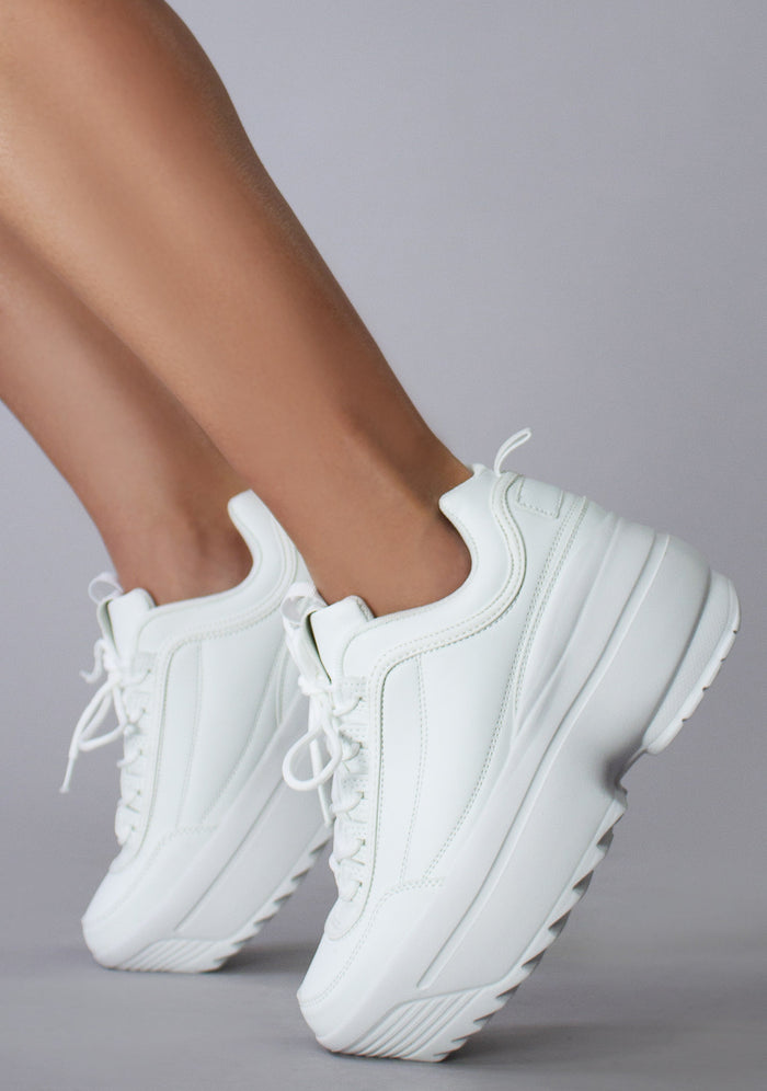 Side view of the Berness LILY 5005 Dream Cypher white platform sneakers on-model, showcasing the detailed side stitching and chunky sole profile.