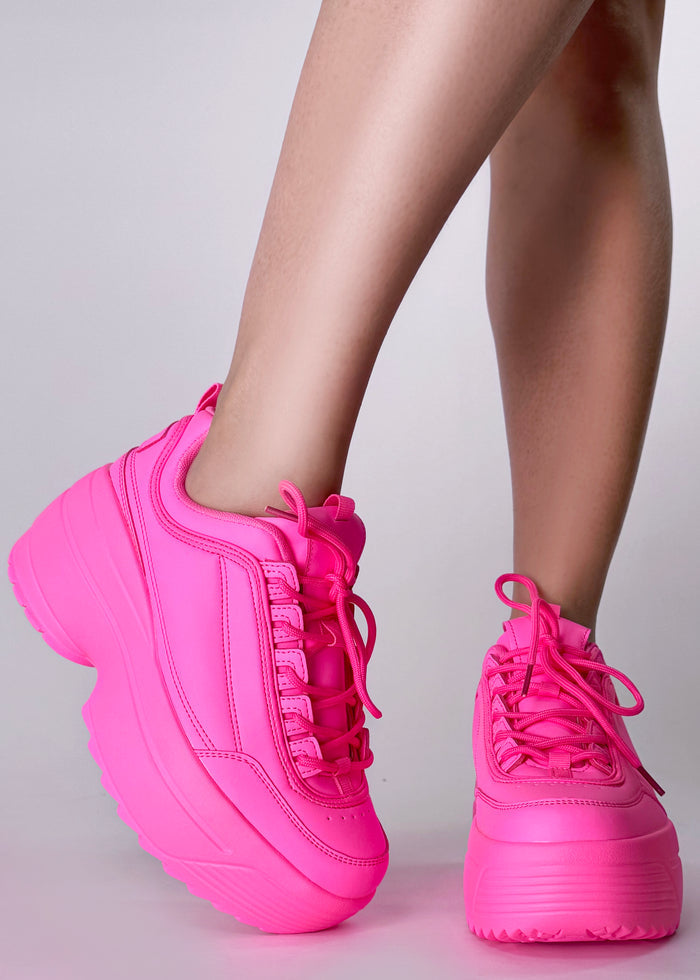Berness LILY 5005 Neon Riot Hot Pink Rave Platform Sneakers in hot pink vegan leather with chunky platform outsole and lace-up closure worn by model — side view