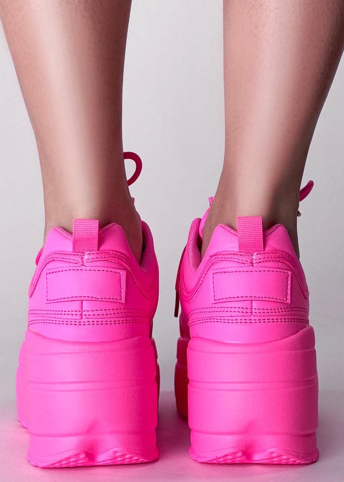 Berness LILY 5005 Neon Riot Hot Pink Rave Platform Sneakers in hot pink vegan leather with chunky Y2K platform outsole worn by model — back view