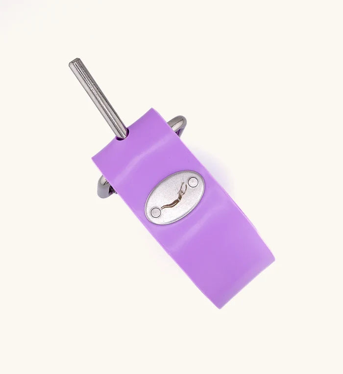 Close-up of a bright purple rubber weight belt buckle with a stainless steel pin and oval metal release clasp from the Manatee Moon Dive Belt by Bright Buoy Diving.