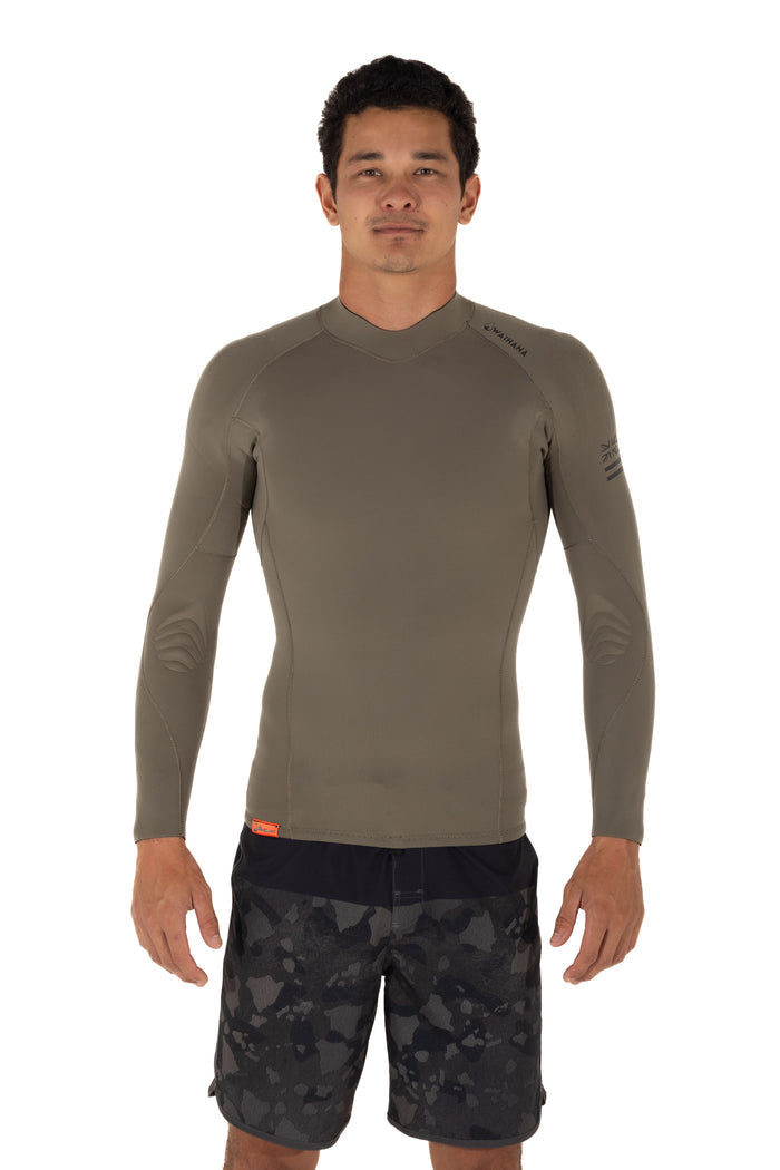 Male model wearing the Waihana Men's Ranger Green long-sleeve surf rashguard top with Waihana branding on the chest and sleeve, paired with dark camo board shorts, shown from the front against a white background.