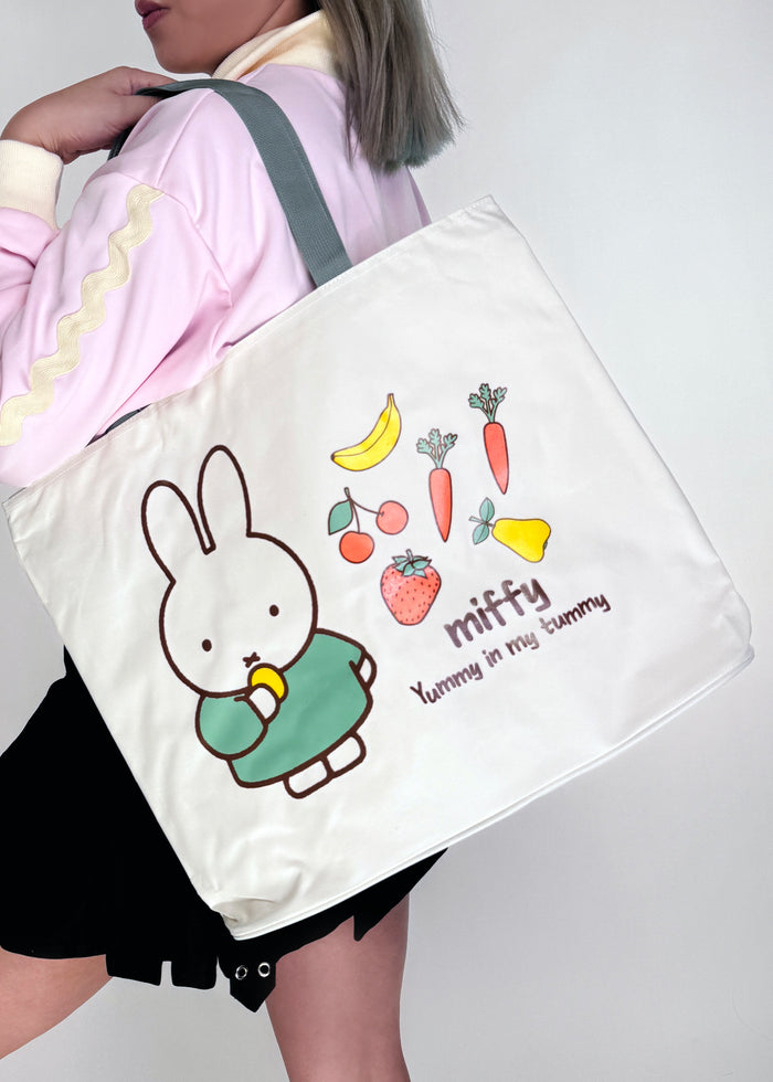 Miffy Yum Yum Large Beach Tote in white multi with full-front Miffy yum yum graphic on durable poly-canvas beach tote bag — model view