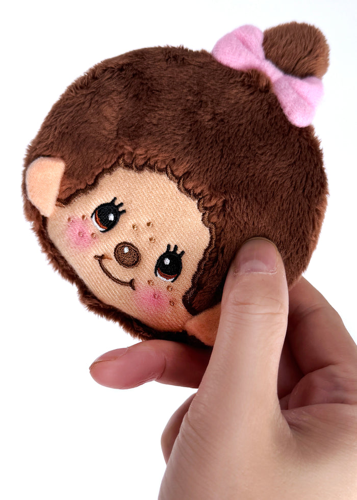 Sekiguchi Monchhichi-Chan Face Plush Coin Bag in brown with embroidered Monchhichi-Chan face and bell charm on soft plush kawaii coin bag — model view