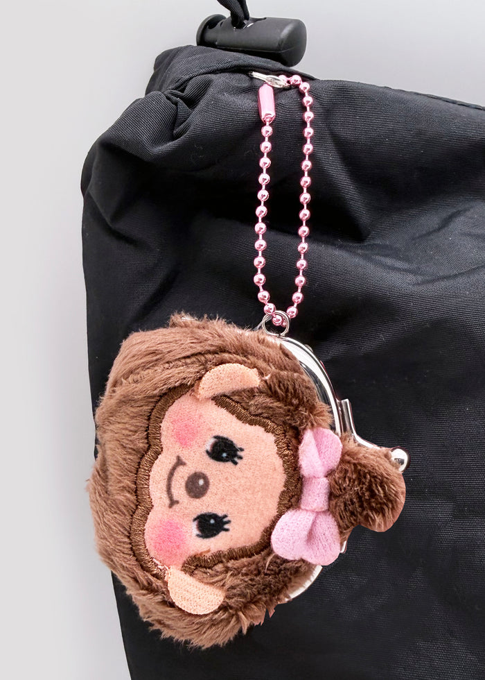 Sekiguchi Monchhichi-Chan Face Plush Mini Coin Bag in brown with embroidered Monchhichi-Chan face on soft plush kawaii mini coin bag — model view