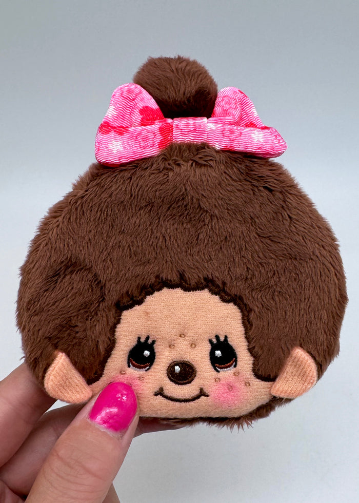 Sekiguchi Monchhichi-Chan Floral Bow Plush Coin Bag in brown with embroidered Monchhichi-Chan face and floral bow on kawaii plush coin bag — model view