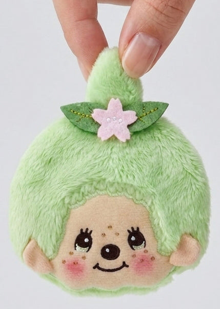 Sekiguchi Monchhichi-Chan Matcha Green Plush Coin Bag held in hand showing size — detail view