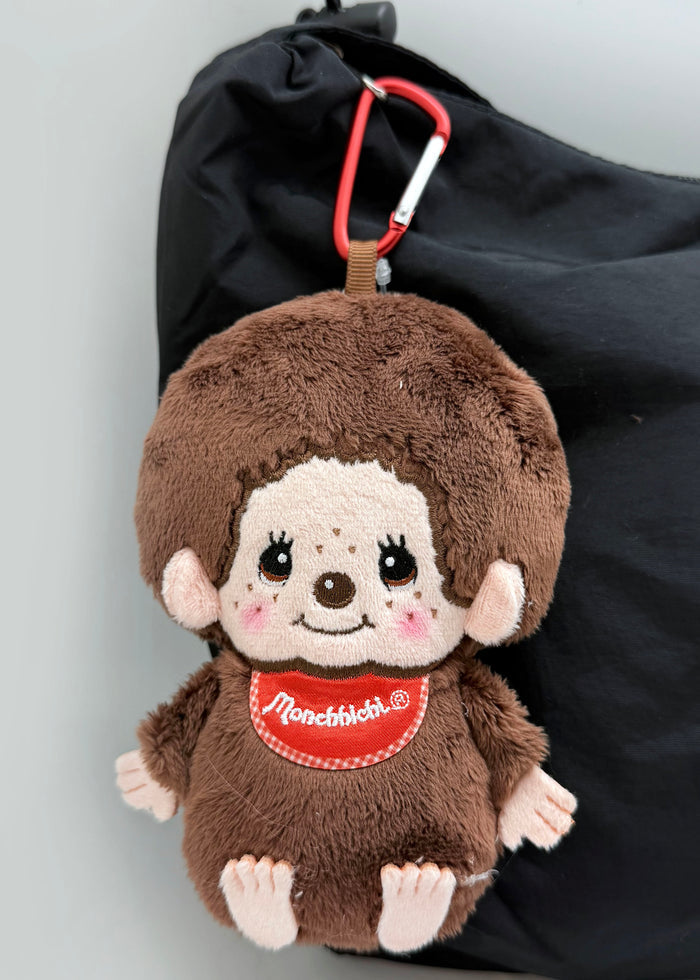 Sekiguchi Monchhichi-Kun Plush Mascot Carabiner Pouch in brown with Monchhichi-Kun plush figure and carabiner hook on kawaii mascot pouch — model view