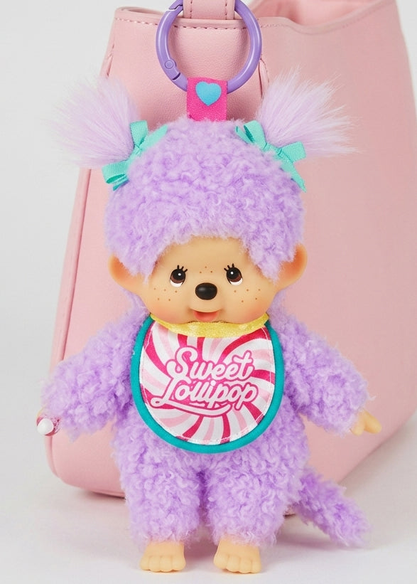 Sekiguchi Monchhichi Sweet Lollipop Purple Plush Mascot Keychain clipped to pink bag — styled view