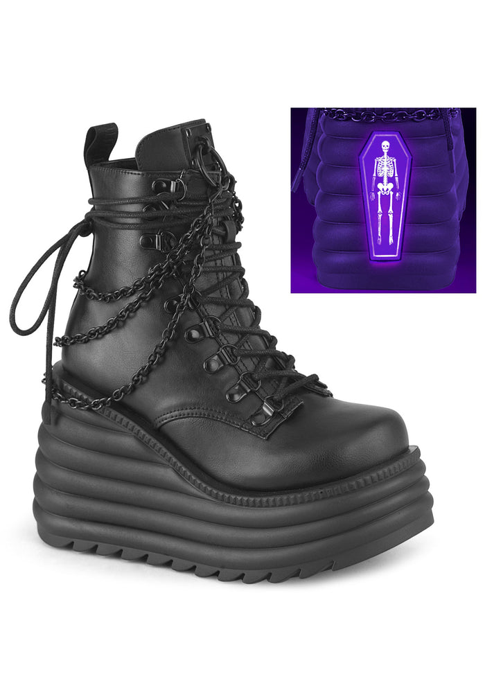 Demonia MORTE 65 Black Rave Platform Boots in black vegan leather with metal chain drape accents and UV reactive skeletal coffin detail — front view