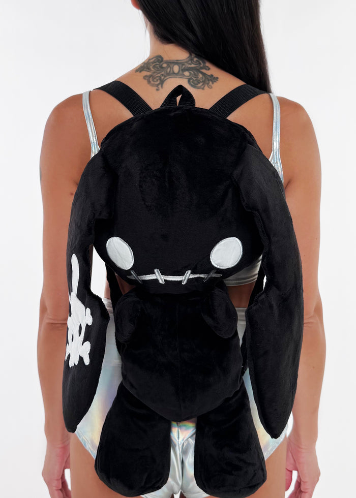 Sleepyville Critters Naughty Bunny Black Plush Backpack in black with 3D plush bunny design and skull patch ear accent on rave festival backpack — front view, styled