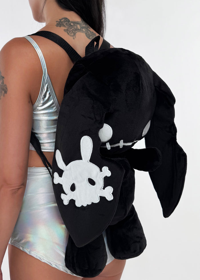Sleepyville Critters Naughty Bunny Black Plush Backpack in black with 3D plush bunny design and skull patch ear accent on rave festival backpack — side view, styled