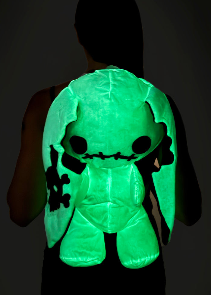 Sleepyville Critters Naughty Bunny Glow in the Dark Plush Backpack in white black with 3D bunny plush, glow-in-the-dark face, and skull patch ear on kawaii goth rave backpack — glow detail view