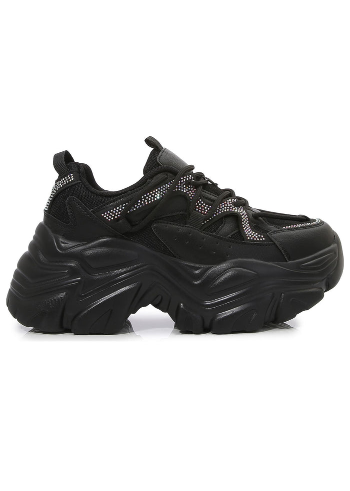Berness Nikki Black Platform Sneakers featuring a chunky wavy black platform sole, mesh panels, and shimmering rhinestone details.