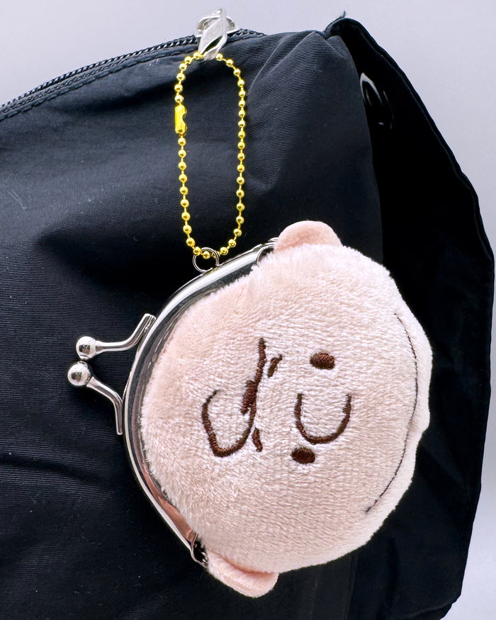 Peanuts Charlie Brown Face Plush Coin Bag in nude with Charlie Brown face embroidered on soft plush kawaii coin bag with twist clasp — model view