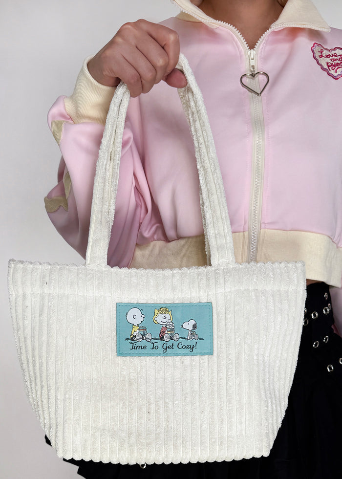 Peanuts Snoopy & Friends Corduroy Tote in offwhite with Snoopy friends woven patch on soft corduroy festival tote bag — model view