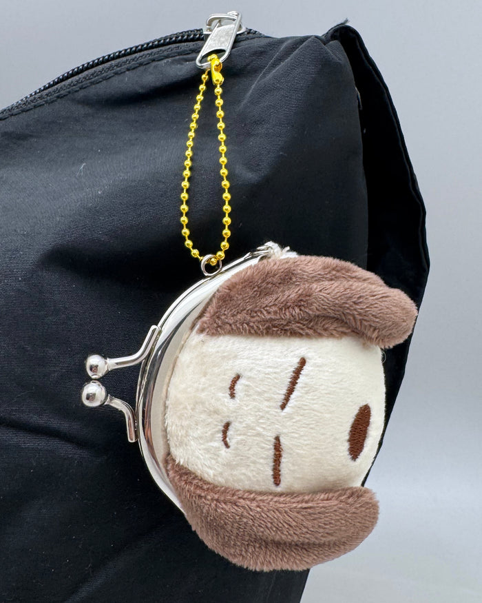 Peanuts Snoopy Relax Face Plush Coin Bag in brown with Snoopy relaxed expression embroidered on soft plush kawaii coin bag with twist clasp — model view