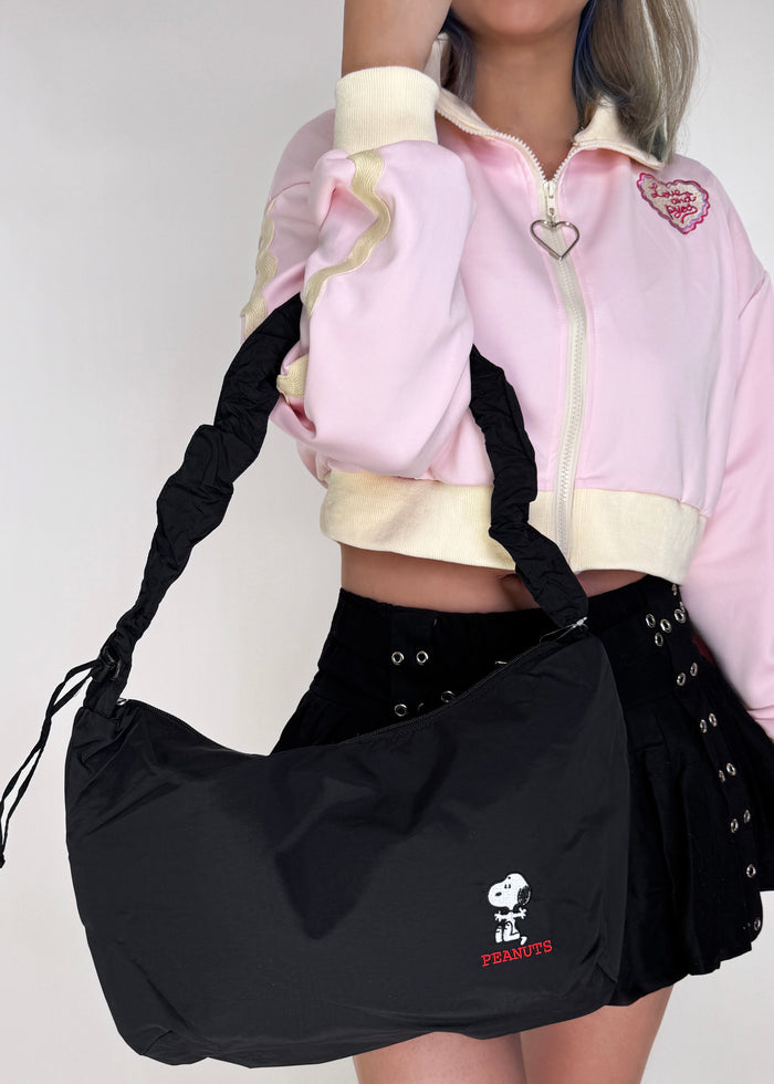 Peanuts Snoopy Say Hi Medium Nylon Black Shoulder Bag in black red with Snoopy Say Hi embroidery on water-resistant nylon shoulder crossbody bag — model view