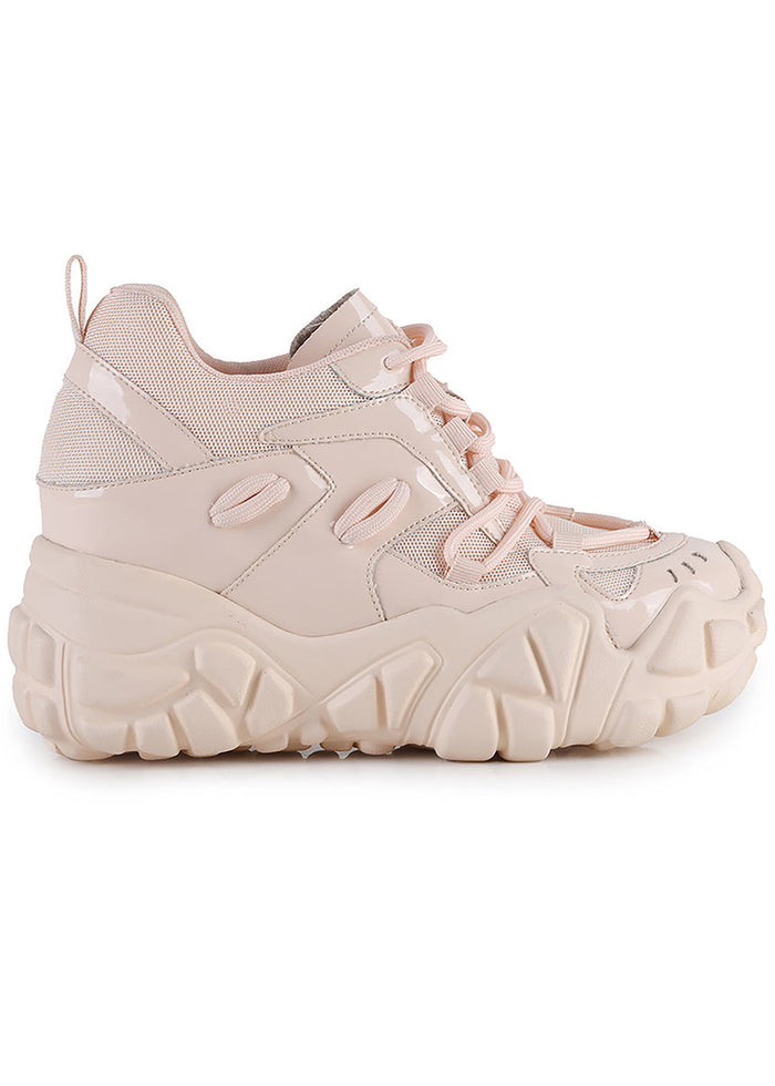 Side studio view of Anthony Wang PERSIMMON 01 Neutral Vibes Nude platform sneakers featuring a glossy monochrome nude patent vegan leather upper with wavy accent panels on a matching chunky nude wedge platform sole