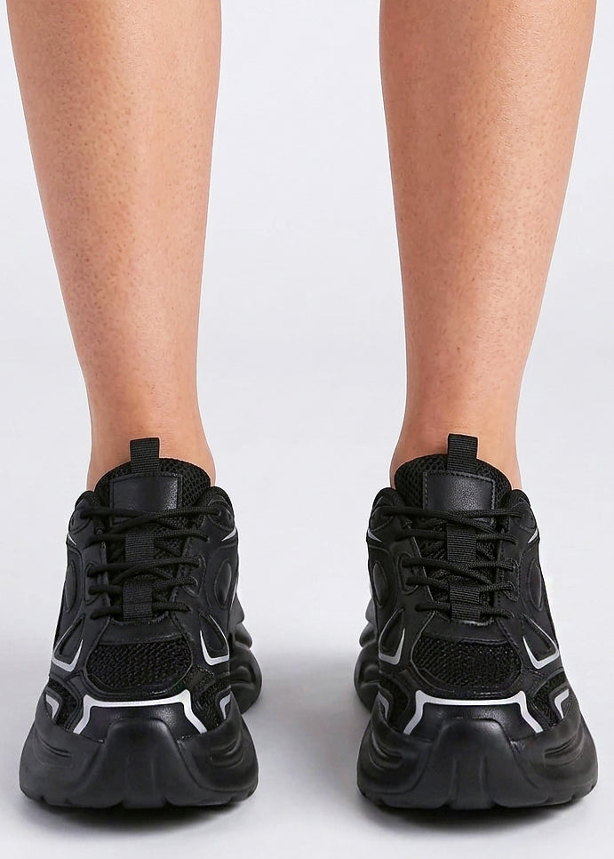 Berness Petra Tektronic Black Platform Sneakers in black with metallic silver strip detailing on chunky platform sneaker — front view, on foot