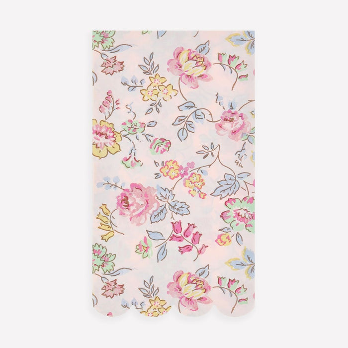 Floral patterned fabric with pink, yellow, and blue flowers on a light pink background