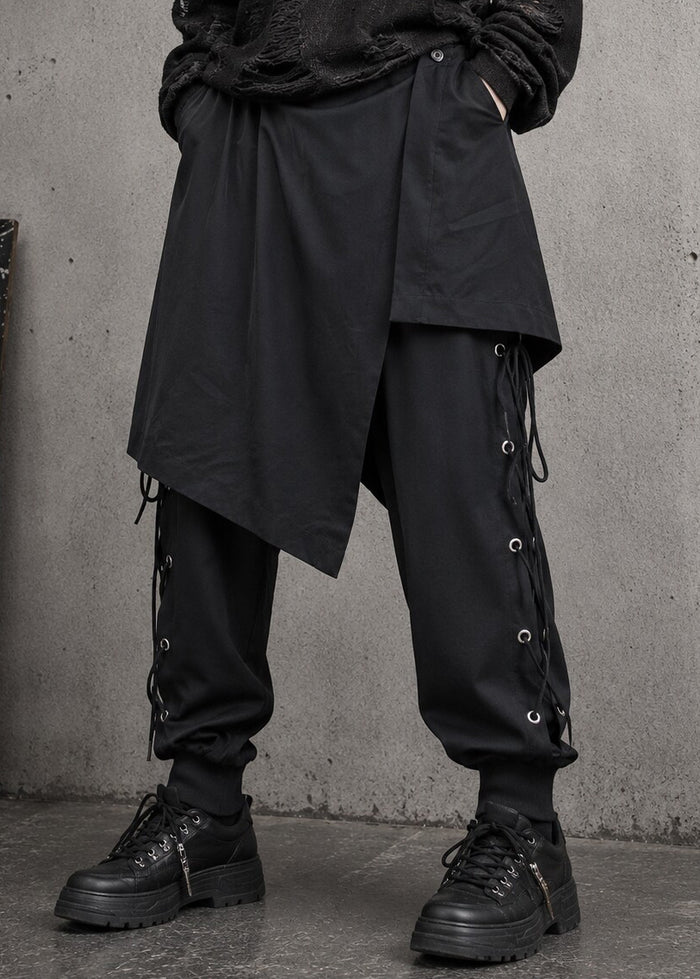 Resham Punk Goth Detachable Harem Pants in black with removable eyelet lace-up skirt harness on pants — front on model
