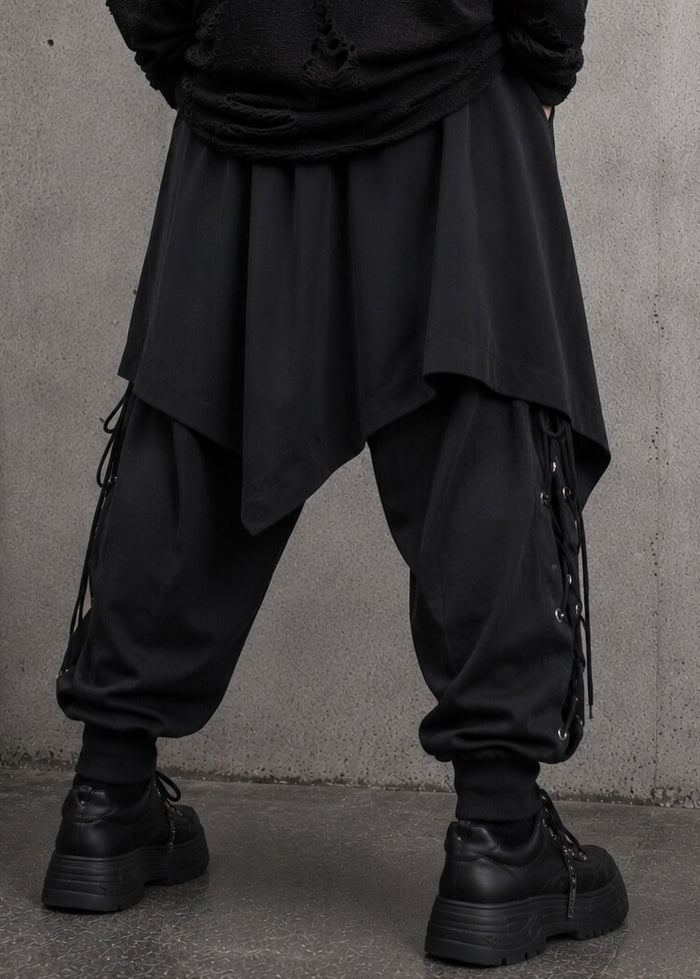 Resham Punk Goth Detachable Harem Pants in black with removable eyelet lace-up skirt harness on pants — back on model
