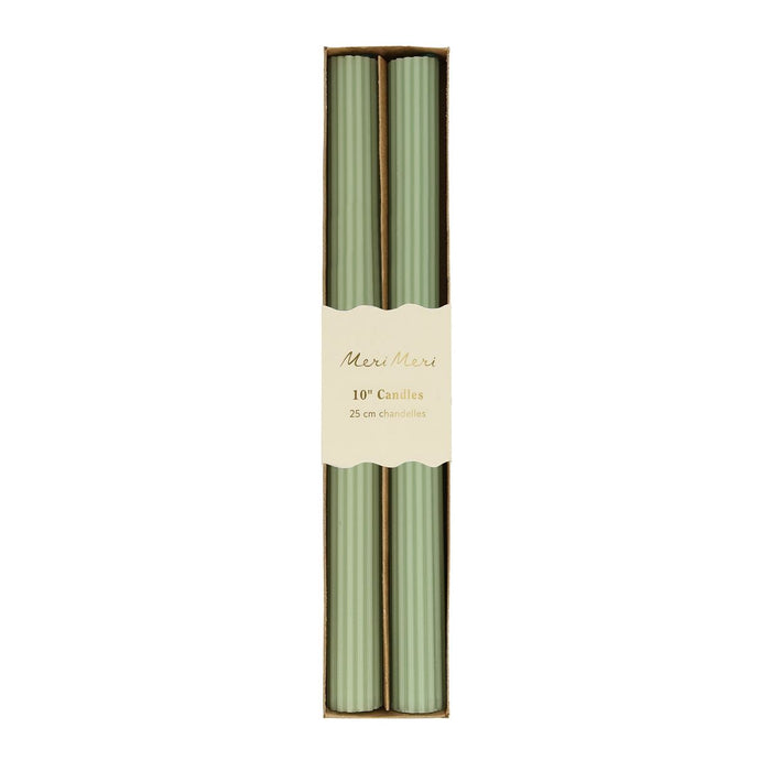 Two green candles in a cardboard box with a Maxi Marie label on a white background