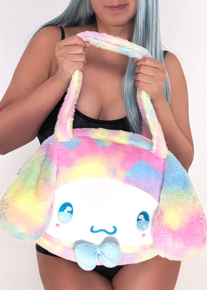 Sanrio Cinnamoroll Pastel Rainbow Anime Eyes Plush Tote in multi with Cinnamoroll face and pastel rainbow anime eyes on plush rave festival tote — model view