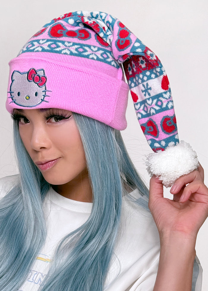 Bioworld Sanrio Hello Kitty Jacquard Santa Hat in multi with Hello Kitty jacquard knit pattern and pom pom accent on kawaii fandom rave festival holiday hat — model view