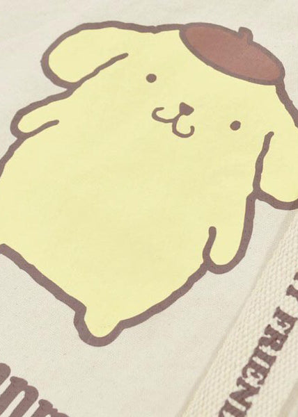 Sanrio Pompompurin Convertible Canvas Tote in yellow with Pompompurin print on 2-way convertible rave festival tote bag — strap detail view