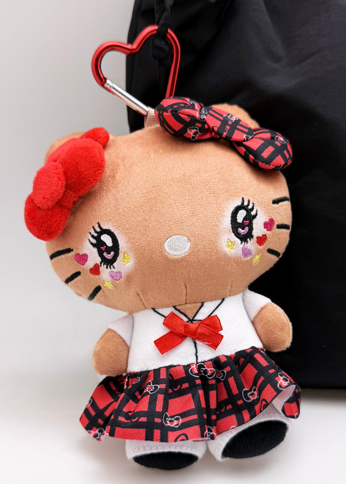 Sanrio Tanned Hello Kitty Student Plush Mascot Carabiner in multi with tanned Hello Kitty in student uniform on plush carabiner rave accessory — model view