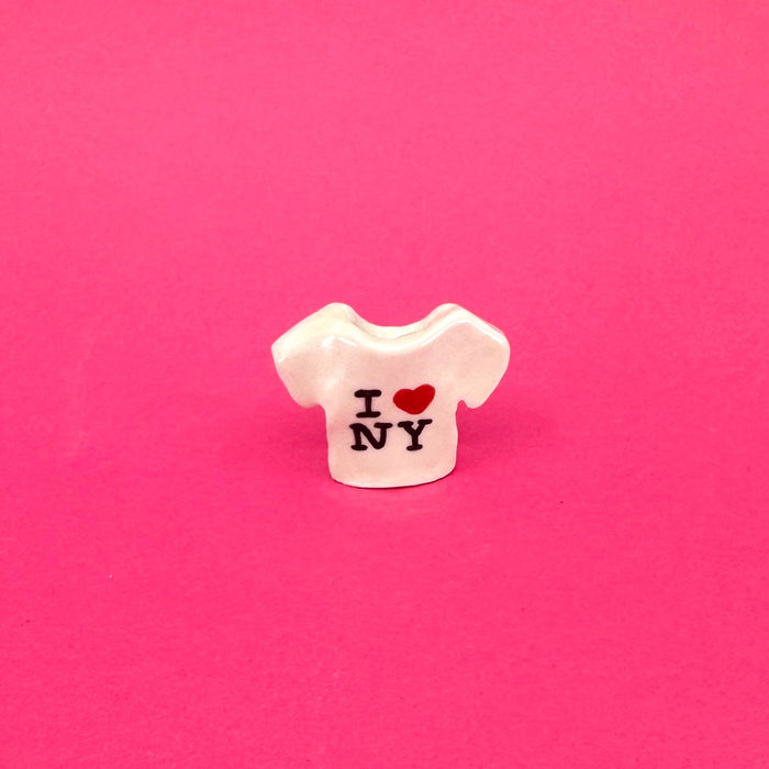 Small white ceramic t-shirt mini vase with 'I ❤️ NY' text on a pink background